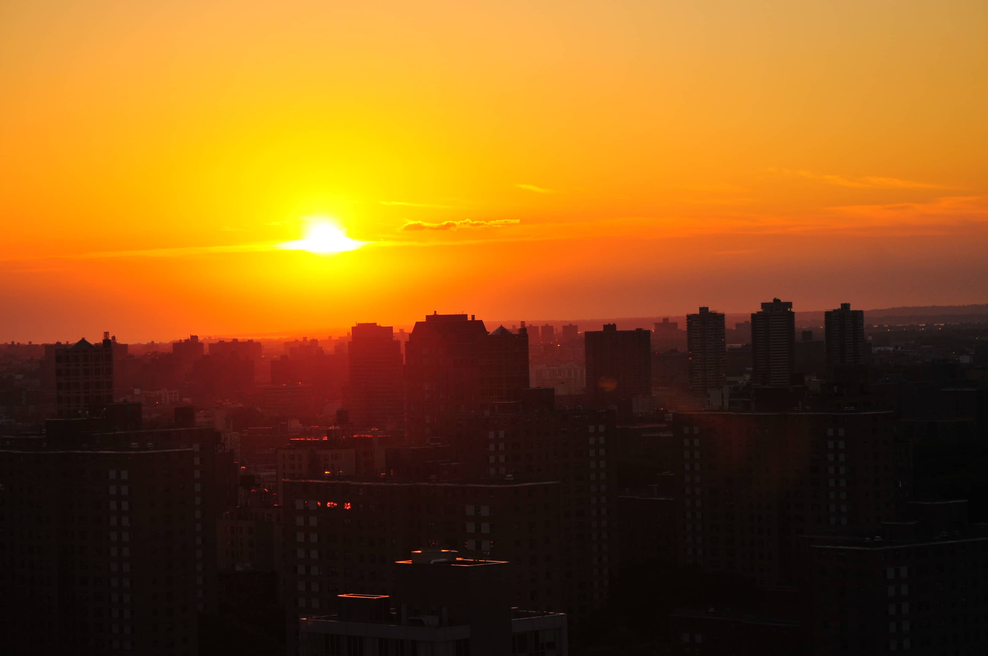 The sun rising over a city skyline